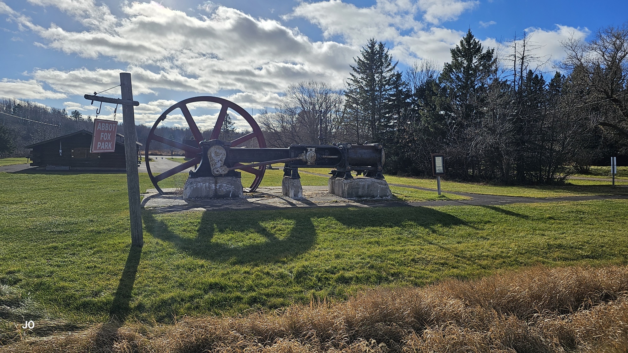 Historic steam engine at Abbot Fox Park on sunny day.