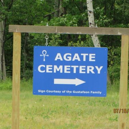 Blue Agate Cemetery sign with directional arrow.