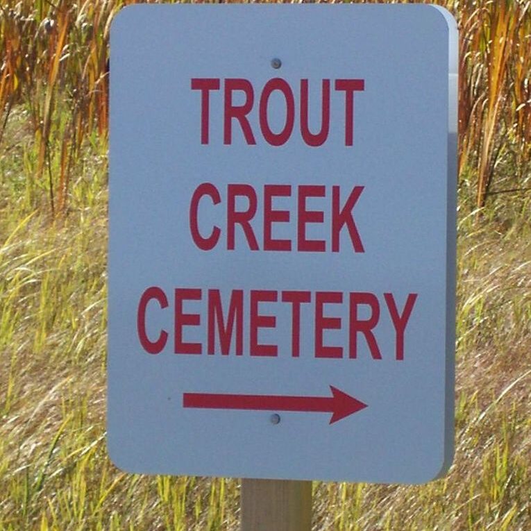 Sign for Trout Creek Cemetery with directional arrow.